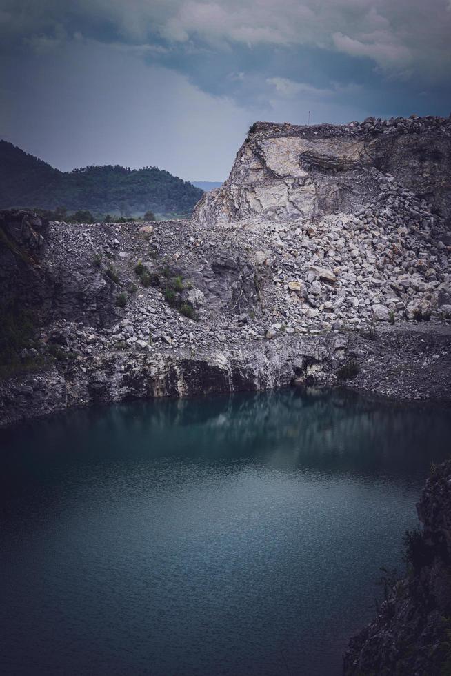 The limestone mountains after the concession explosion during the rainy season form a large and beautiful pond. photo