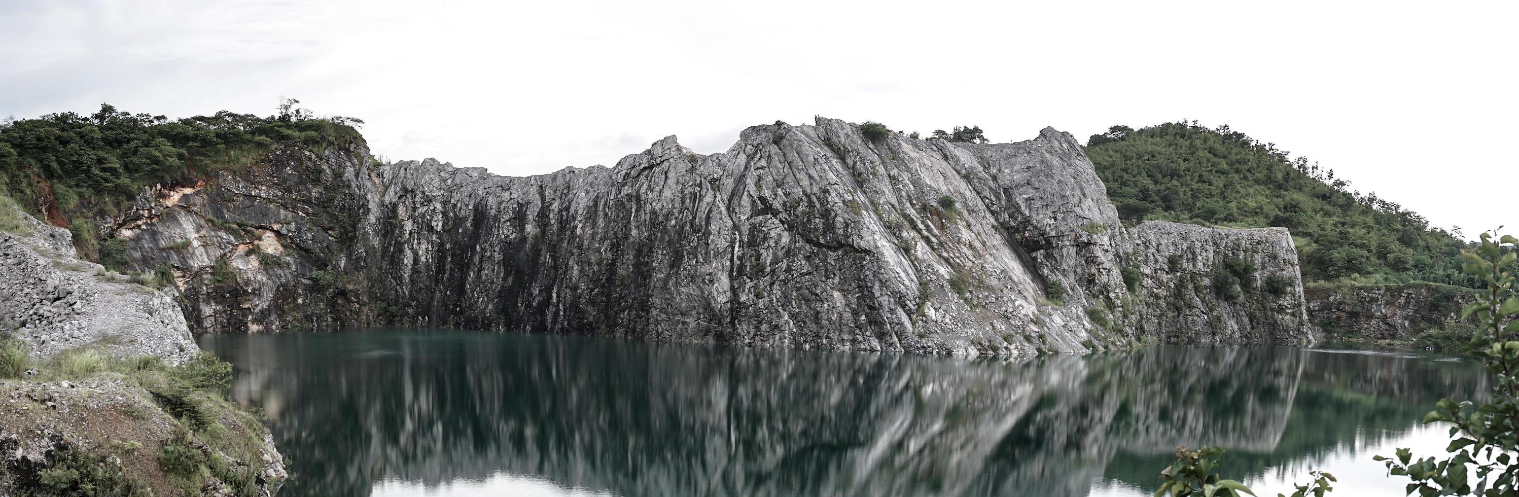The limestone mountains after the concession explosion during the rainy season form a large and beautiful pond. photo