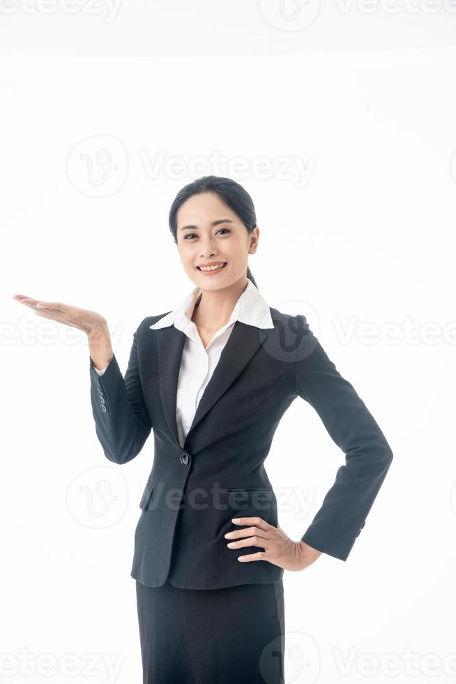 Asian beautiful smart  and young businesswoman with black long hair and suit  is the executive or manager show her hand and smiling with confidence  in successful on isolated white background photo