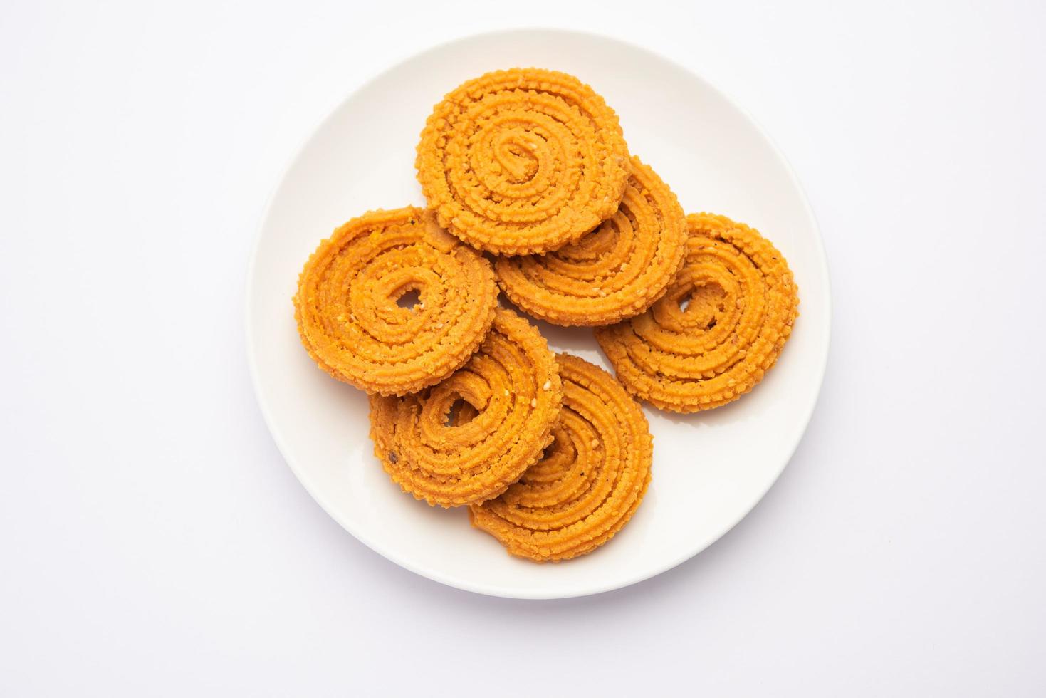 Chakli is a savoury snack from India. It is a spiral shaped snack with a spiked surface photo