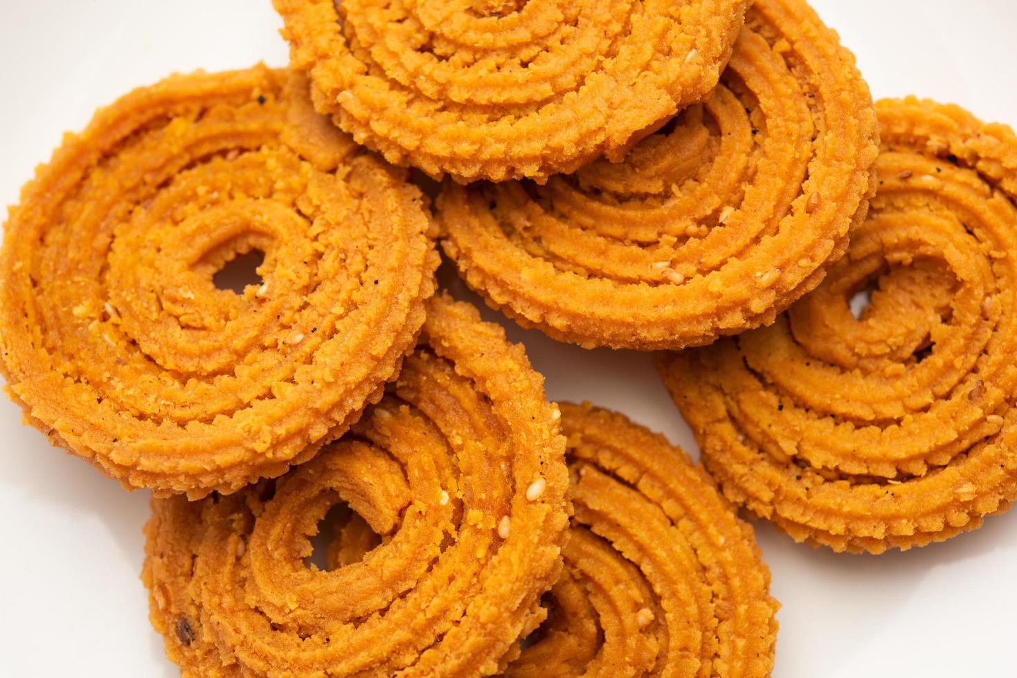 Chakli is a savoury snack from India. It is a spiral shaped snack with a spiked surface photo