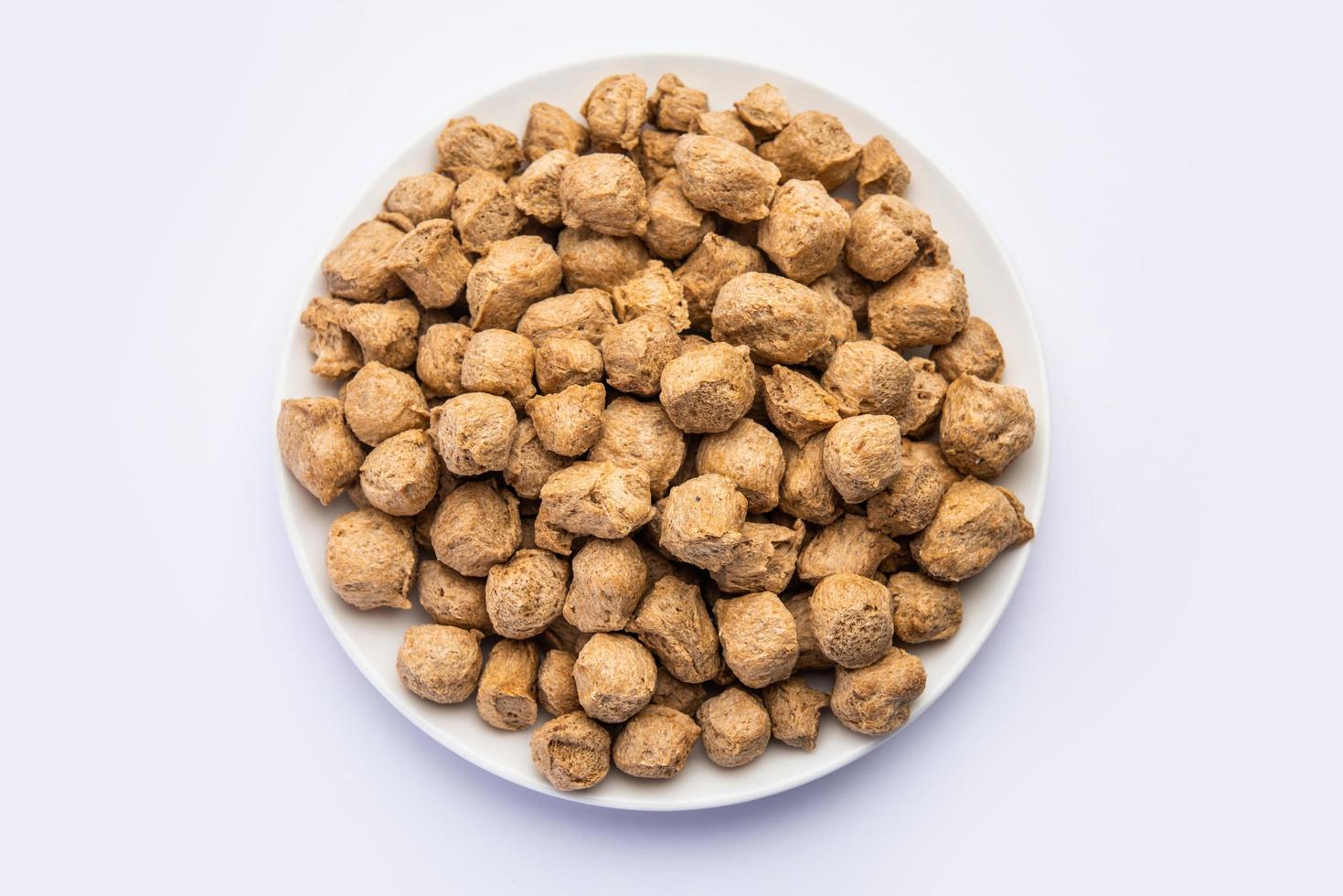 Glycine max or Soya bean or uncooked soybean chunks. Served in a bowl or as a Pile. selective focus photo