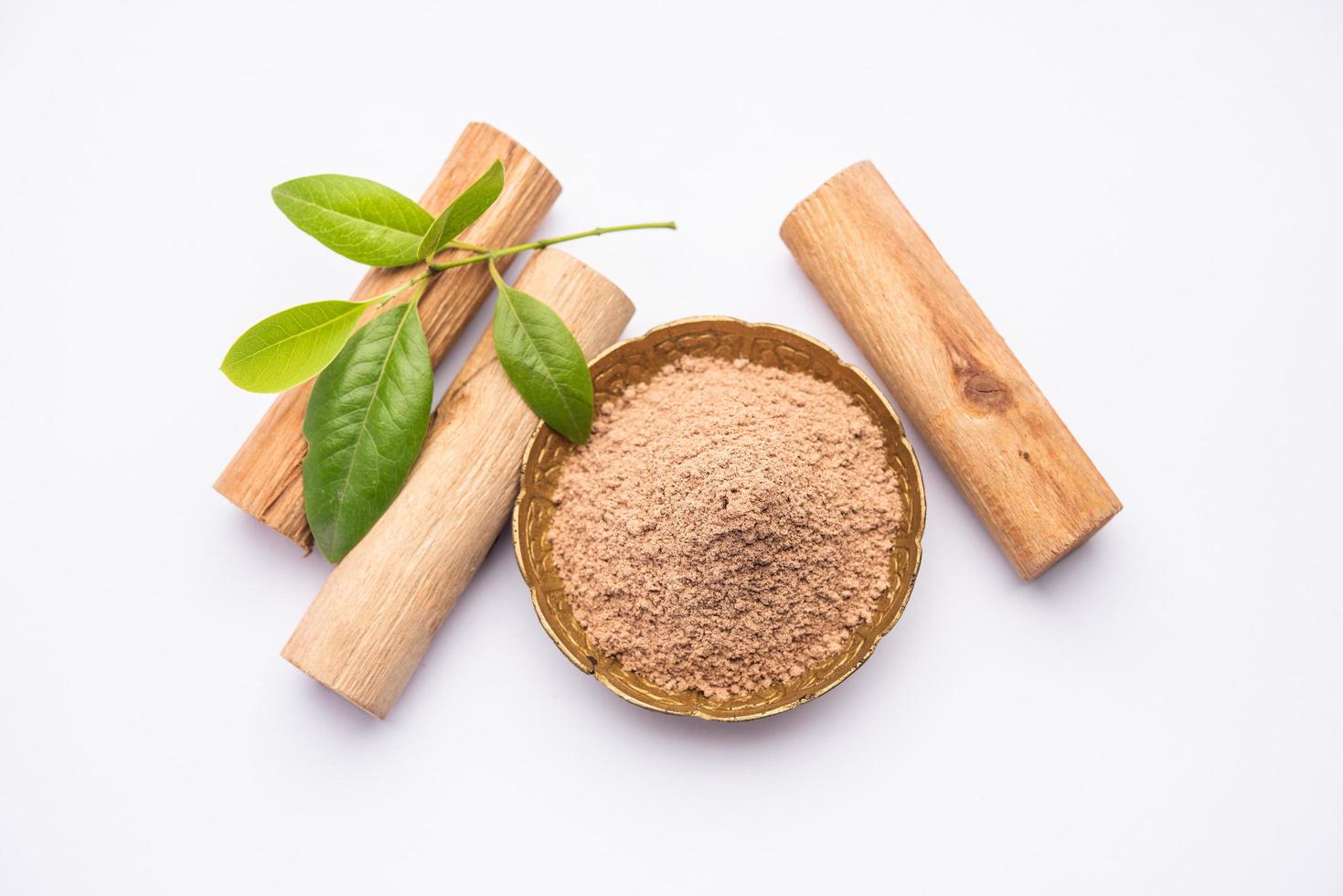Chandan or sandalwood powder with sticks, perfume or oil which retain their fragrance for decades photo