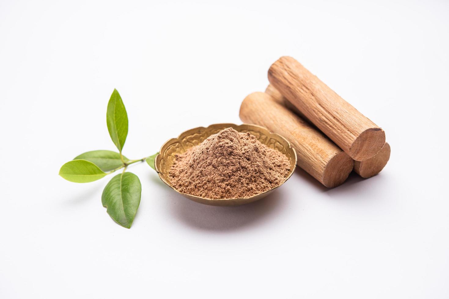 Chandan or sandalwood powder with sticks, perfume or oil which retain their fragrance for decades photo