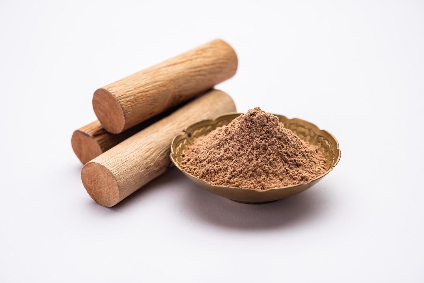 Chandan or sandalwood powder with sticks, perfume or oil which retain their fragrance for decades photo