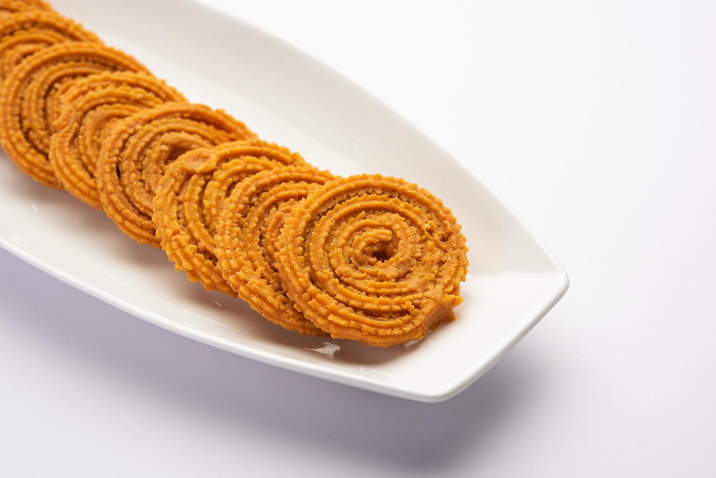 Chakli is a savoury snack from India. It is a spiral shaped snack with a spiked surface photo