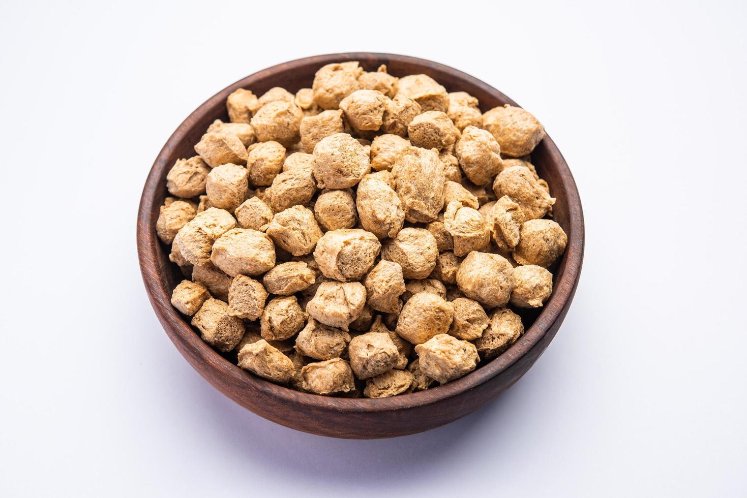 Glycine max or Soya bean or uncooked soybean chunks. Served in a bowl or as a Pile. selective focus photo