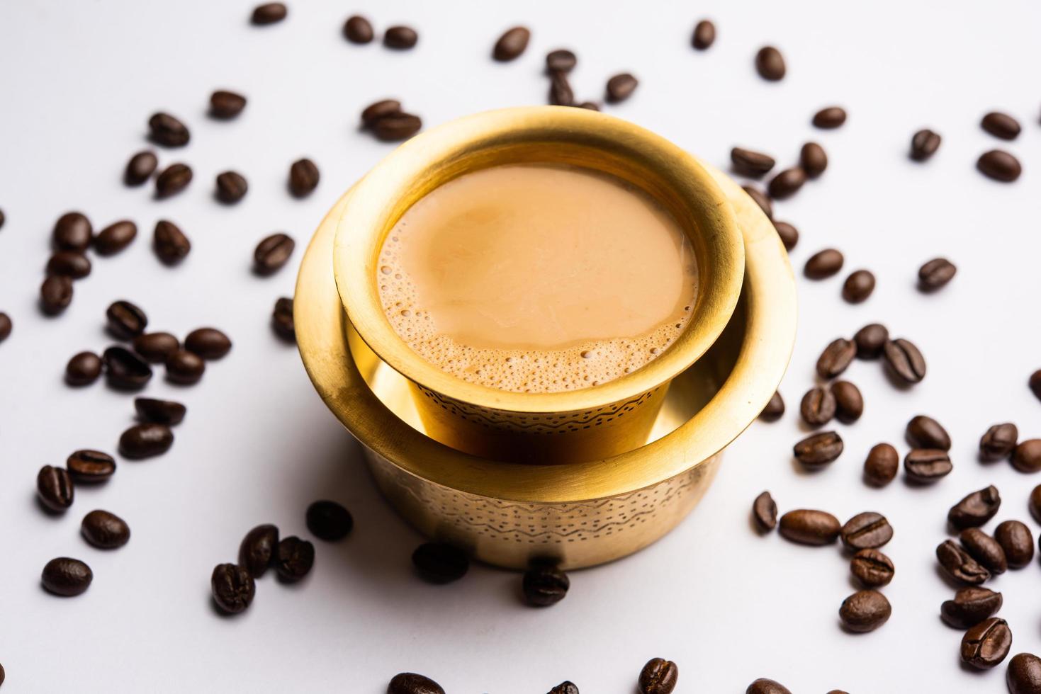 South Indian Filter coffee served in a traditional brass or stainless steel cup photo