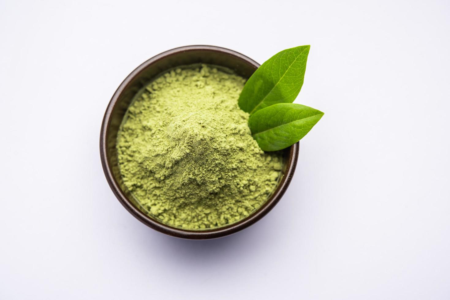 Herbal henna or Mehandi powder in a bowl forming heap, Used for Tattoo or Hair Dye in India photo