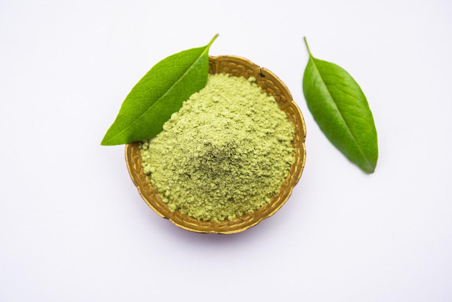 Herbal henna or Mehandi powder in a bowl forming heap, Used for Tattoo or Hair Dye in India photo