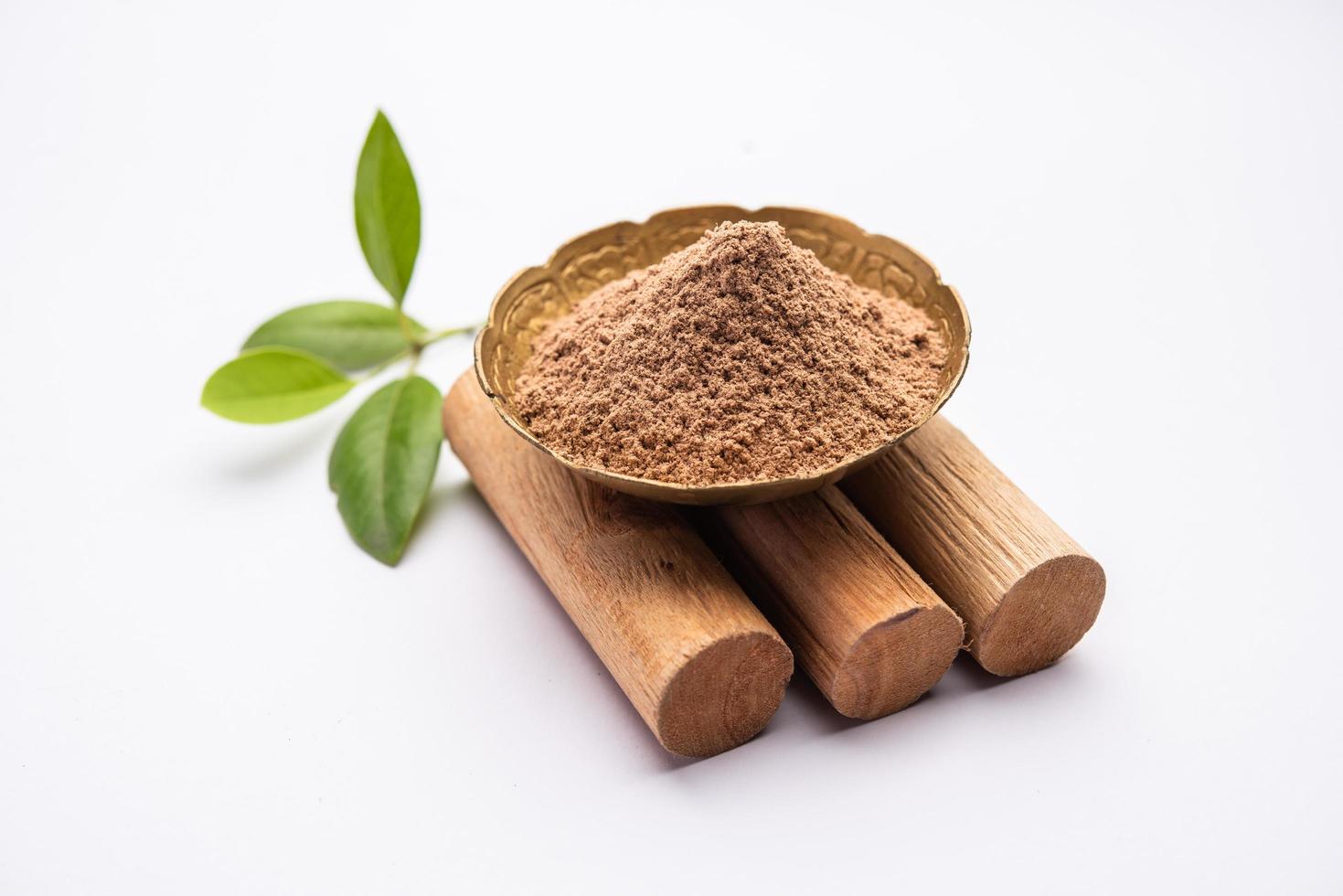 Chandan or sandalwood powder with sticks, perfume or oil which retain their fragrance for decades photo