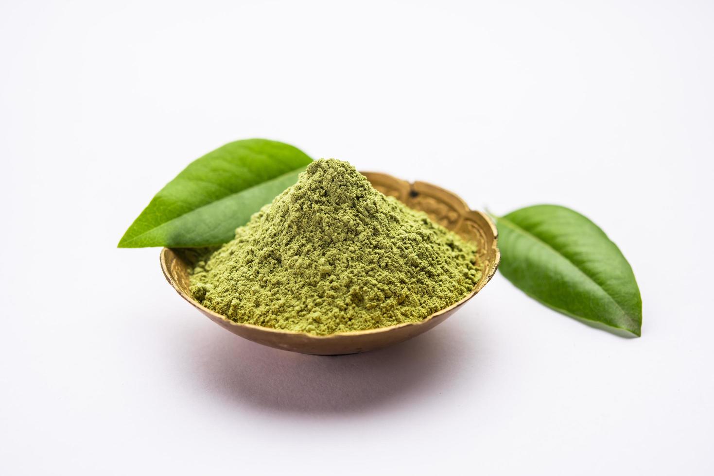 Herbal henna or Mehandi powder in a bowl forming heap, Used for Tattoo or Hair Dye in India photo