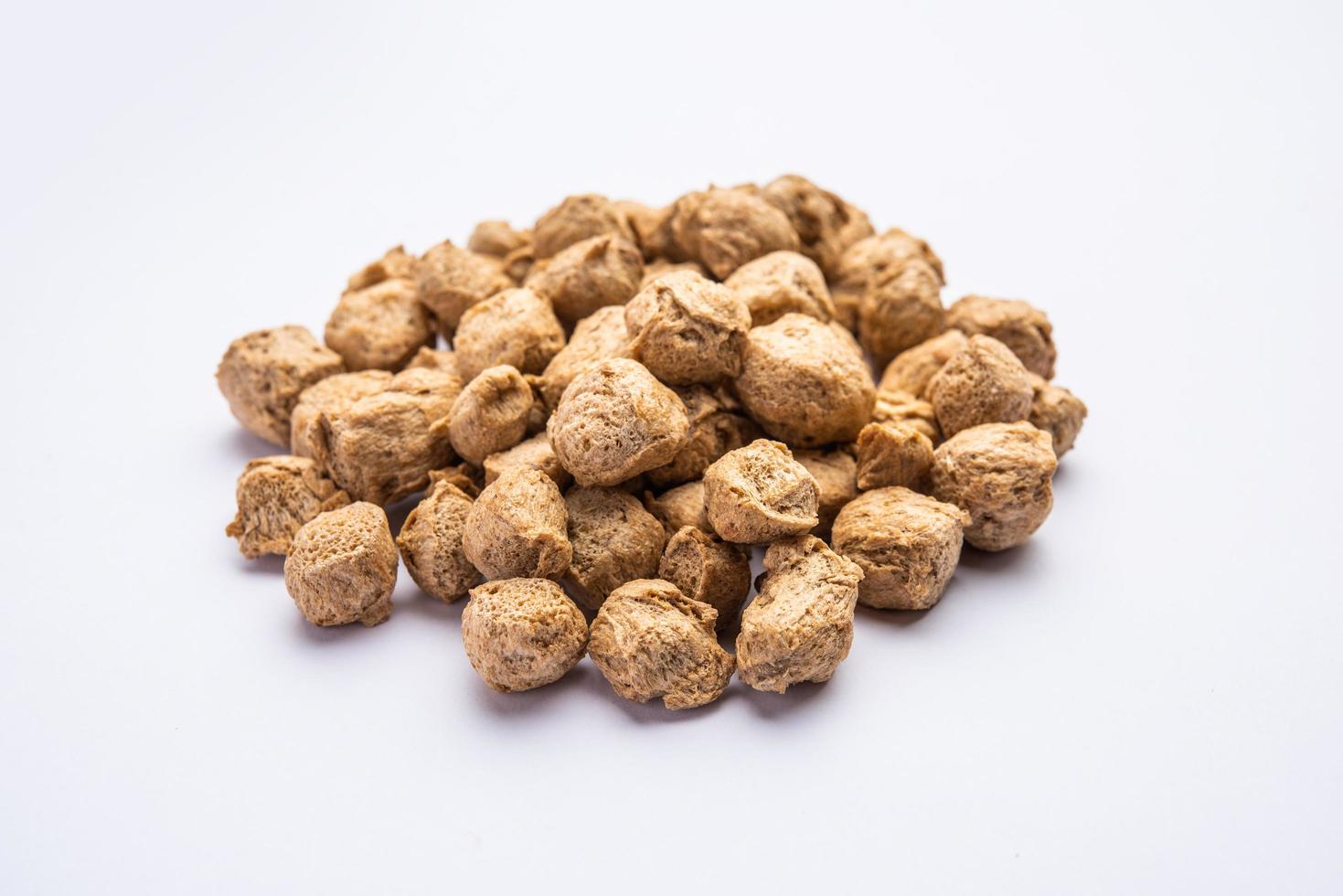 Glycine max or Soya bean or uncooked soybean chunks. Served in a bowl or as a Pile. selective focus photo