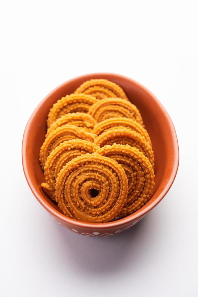 Chakli is a savoury snack from India. It is a spiral shaped snack with a spiked surface photo