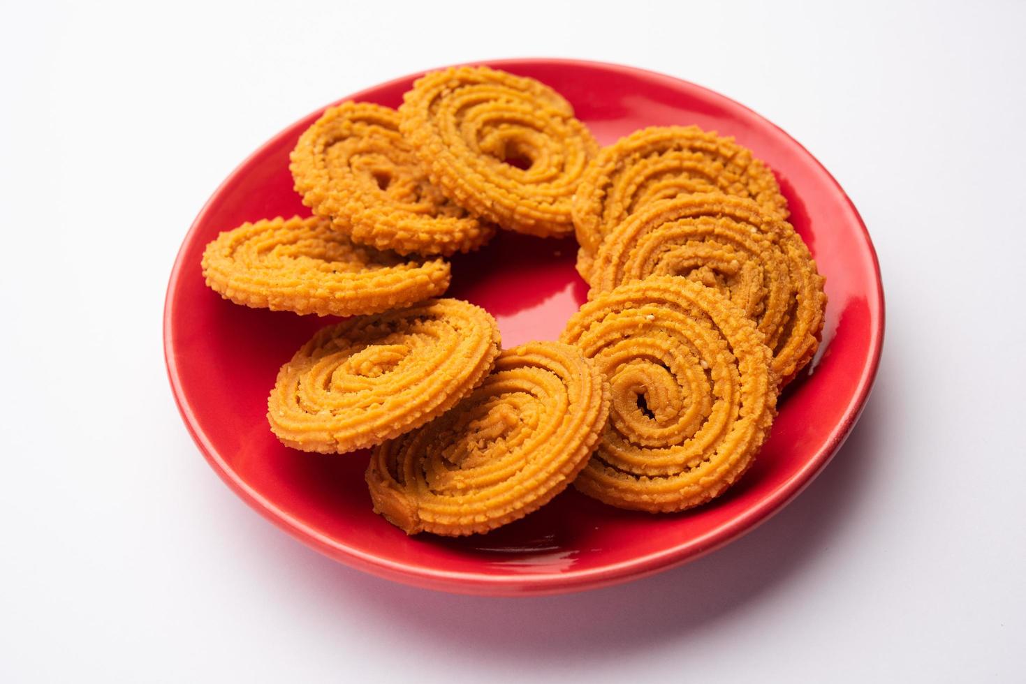 Chakli is a savoury snack from India. It is a spiral shaped snack with a spiked surface photo