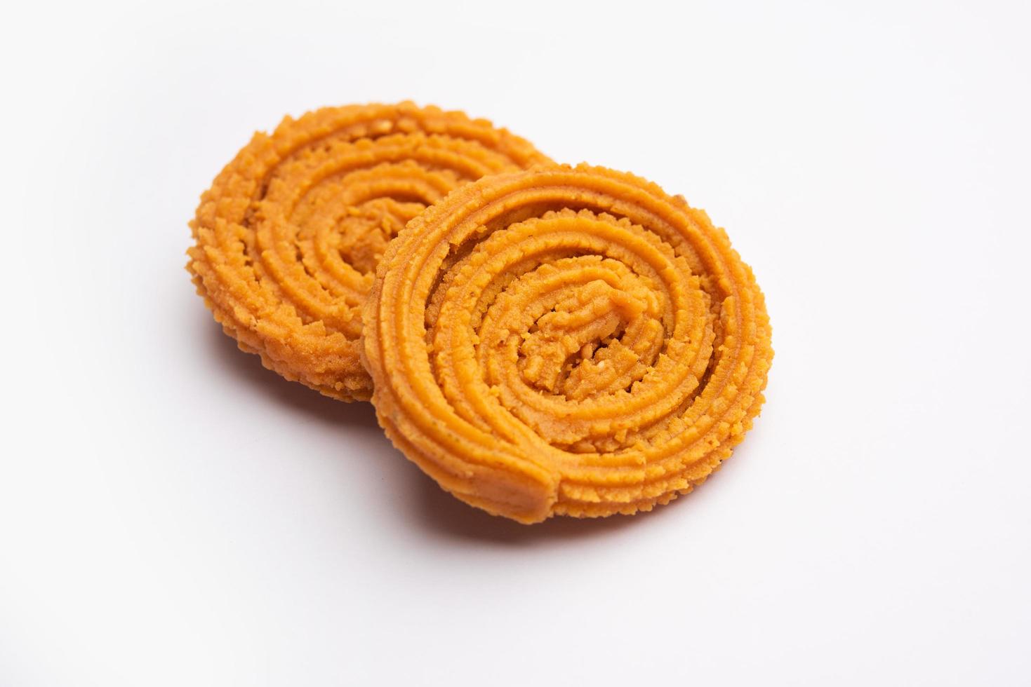 Chakli is a savoury snack from India. It is a spiral shaped snack with a spiked surface photo