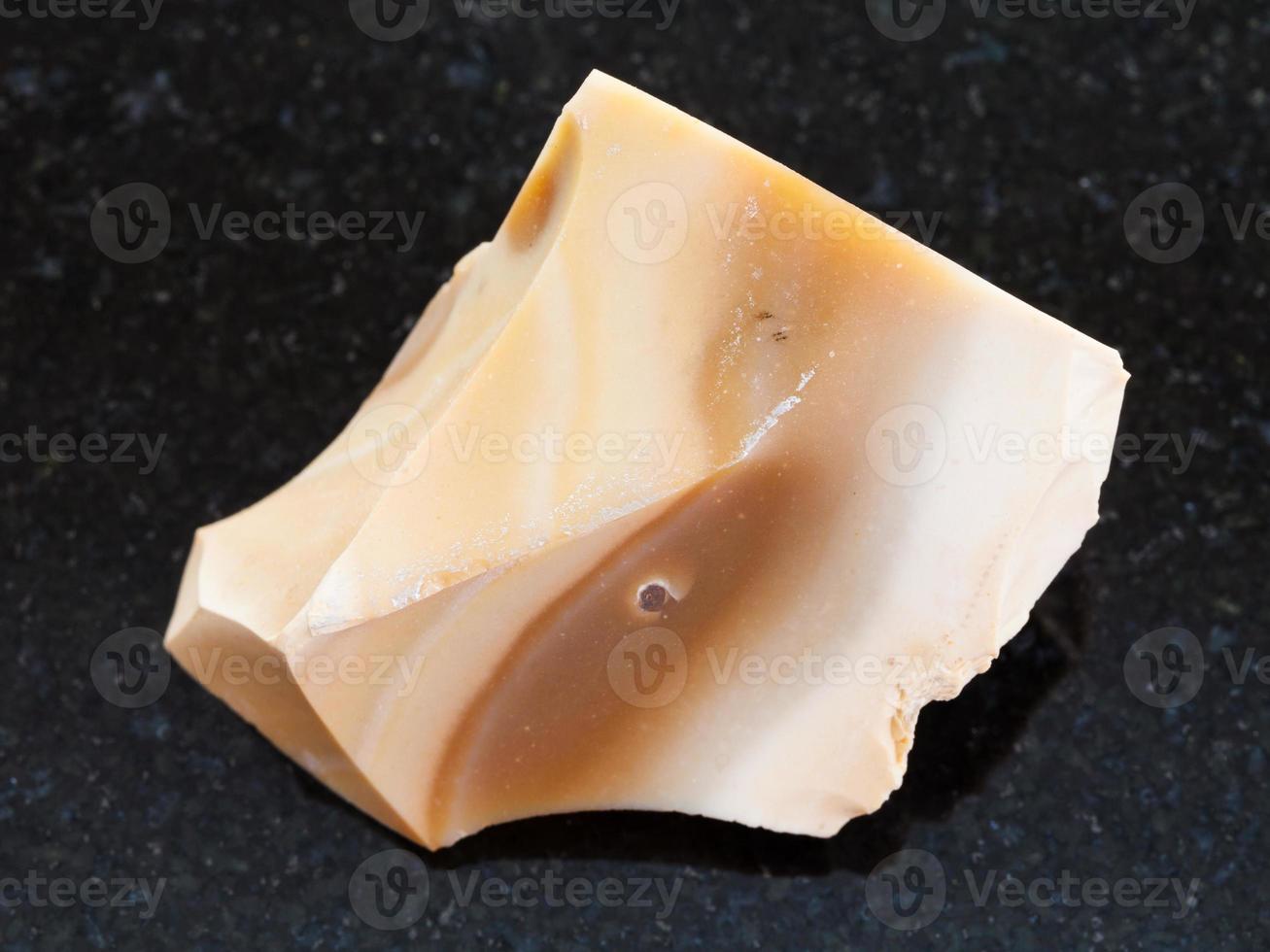 rough brown Flint stone on dark background photo