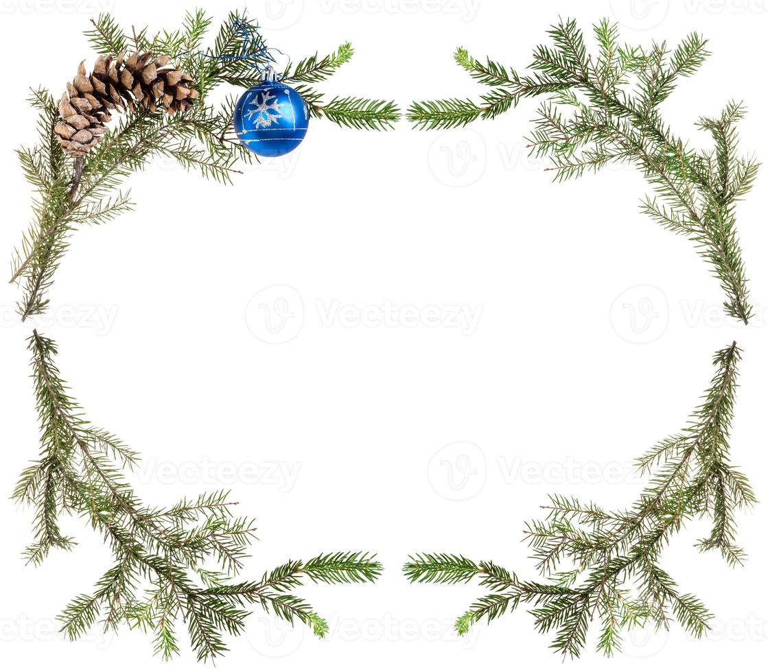 spruce branches with cones and blue ball on white photo