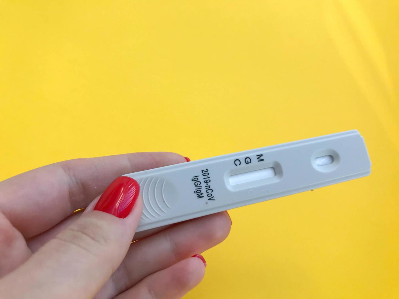 Lab scientist performing rapid diagnostic test RDT for antibodies to detect presence of viral protein antigens expressed by COVID-19 corona virus disease,CDC quick fast antibody point of care testing photo