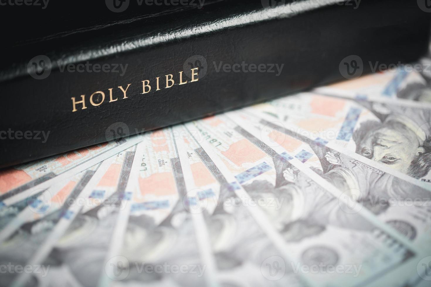 One tenth or tithe is basis on which Bible teaches us to give one tenth of first fruit to God. coins with Holy Bible. Biblical concept of Christian offering, generosity, and giving tithes in church. photo