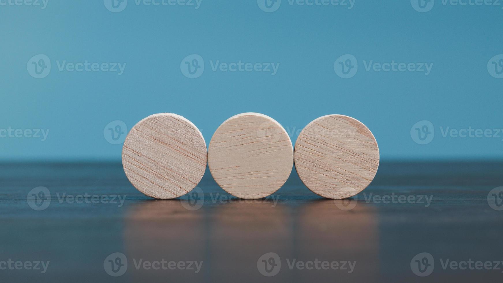Stacking blank wooden cubes on blue background with copy space for input wording and infographic icon. Empty brown wooden object block for symbol icon put technology, zero gravity, business concept. photo