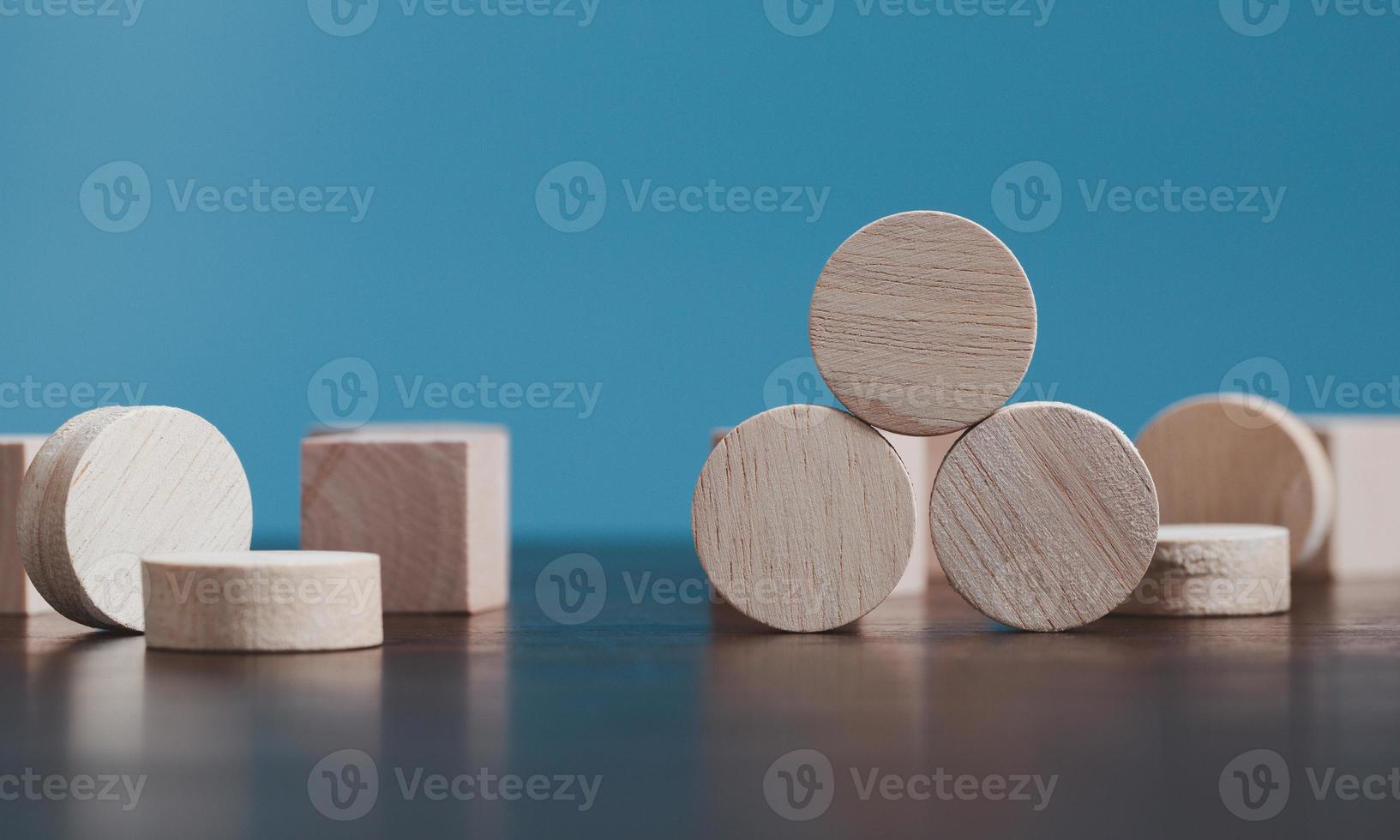 Stacking blank wooden cubes on blue background with copy space for input wording and infographic icon. Empty brown wooden object block for symbol icon put technology, zero gravity, business concept. photo