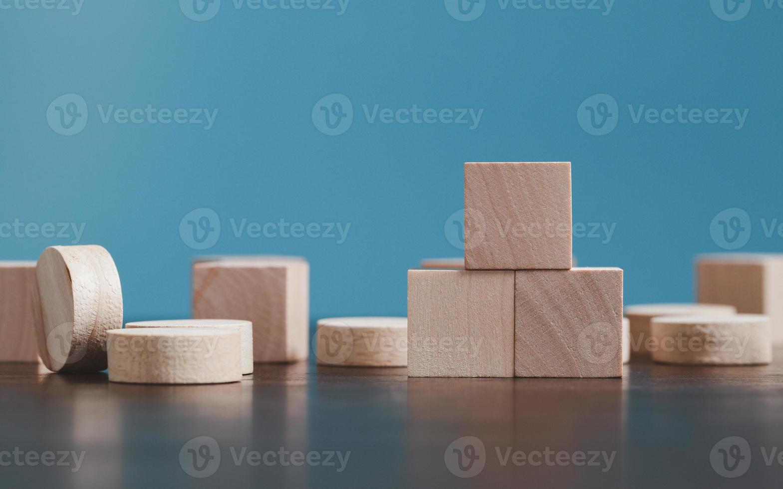 Stacking blank wooden cubes on blue background with copy space for input wording and infographic icon. Empty brown wooden object block for symbol icon put technology, zero gravity, business concept. photo