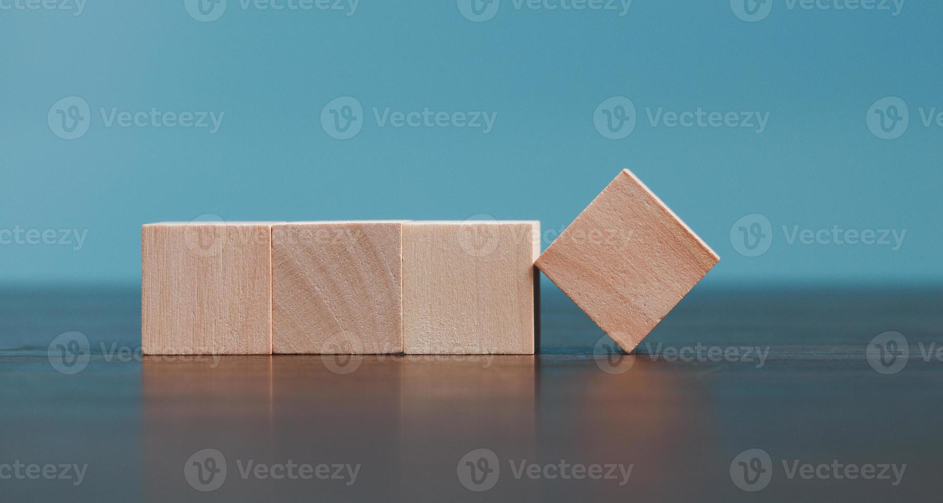 Stacking blank wooden cubes on blue background with copy space for input wording and infographic icon. Empty brown wooden object block for symbol icon put technology, zero gravity, business concept. photo