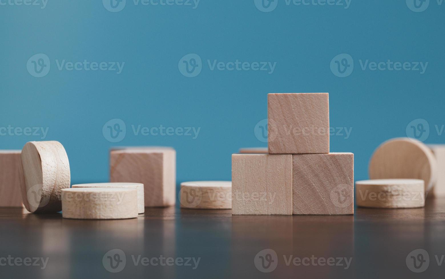 Stacking blank wooden cubes on blue background with copy space for input wording and infographic icon. Empty brown wooden object block for symbol icon put technology, zero gravity, business concept. photo