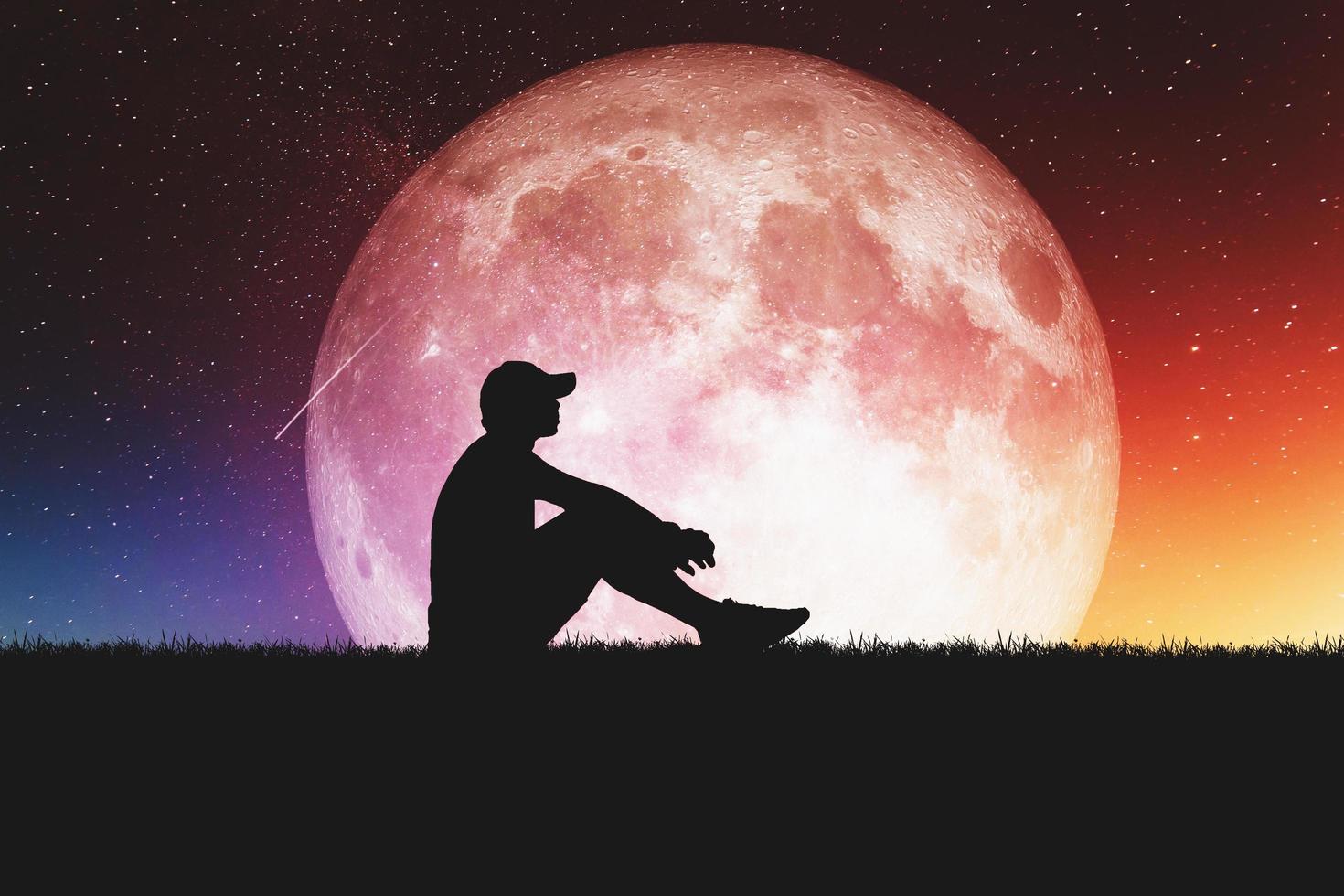 Concept of loneliness and disappointment in love. Sad man sitting element of the picture is decorated by NASA photo