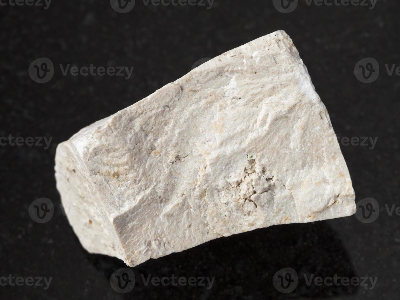 raw chemical limestone stone on dark background photo