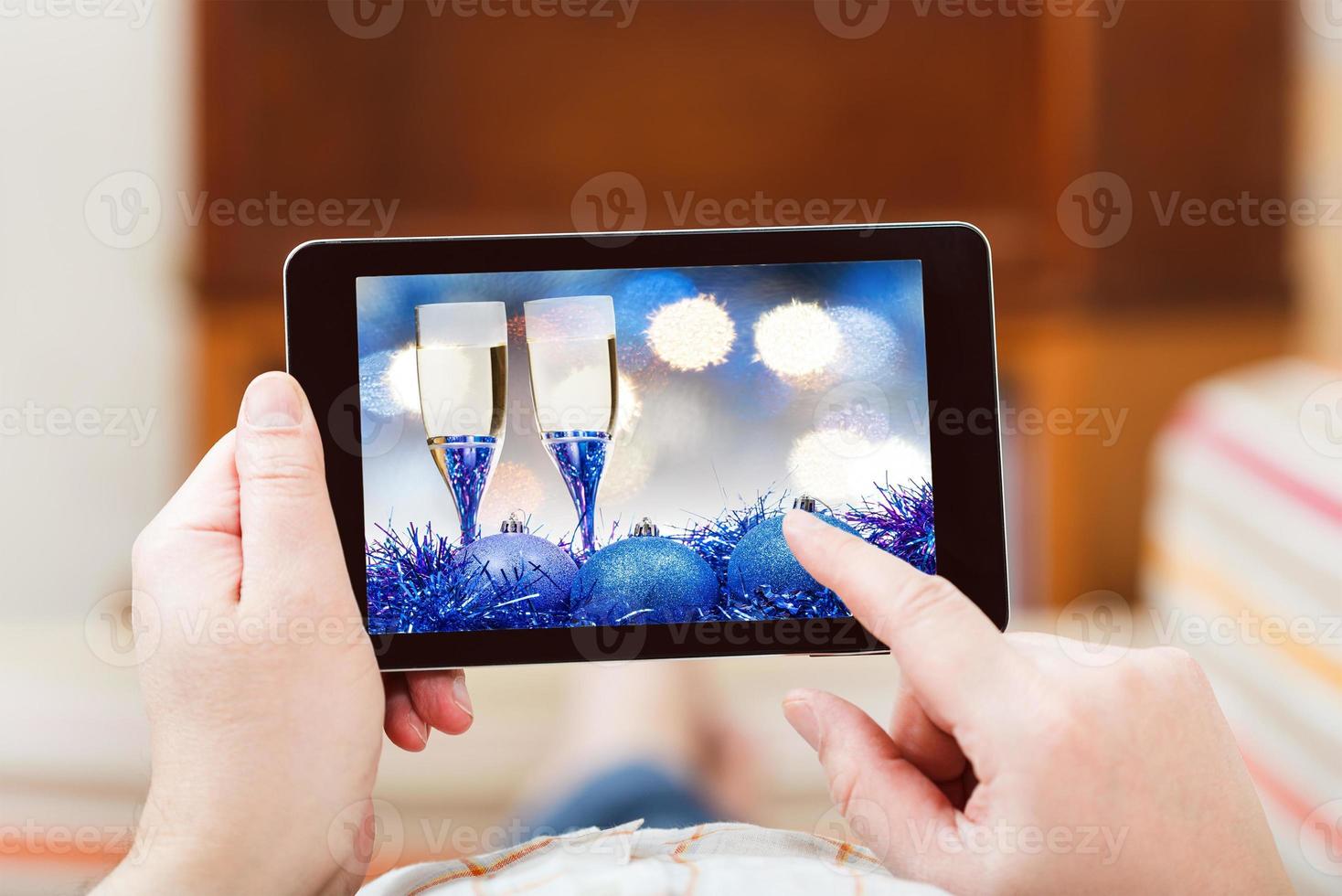 man touches tablet-pc with blue Xmas still life photo