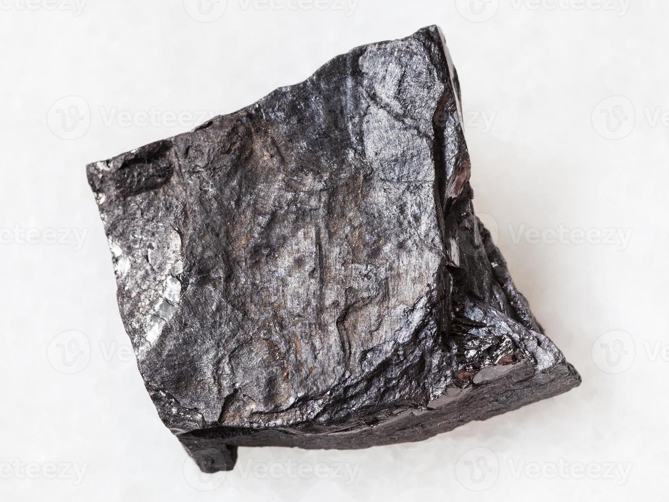 rough carbonaceous shale stone on white photo