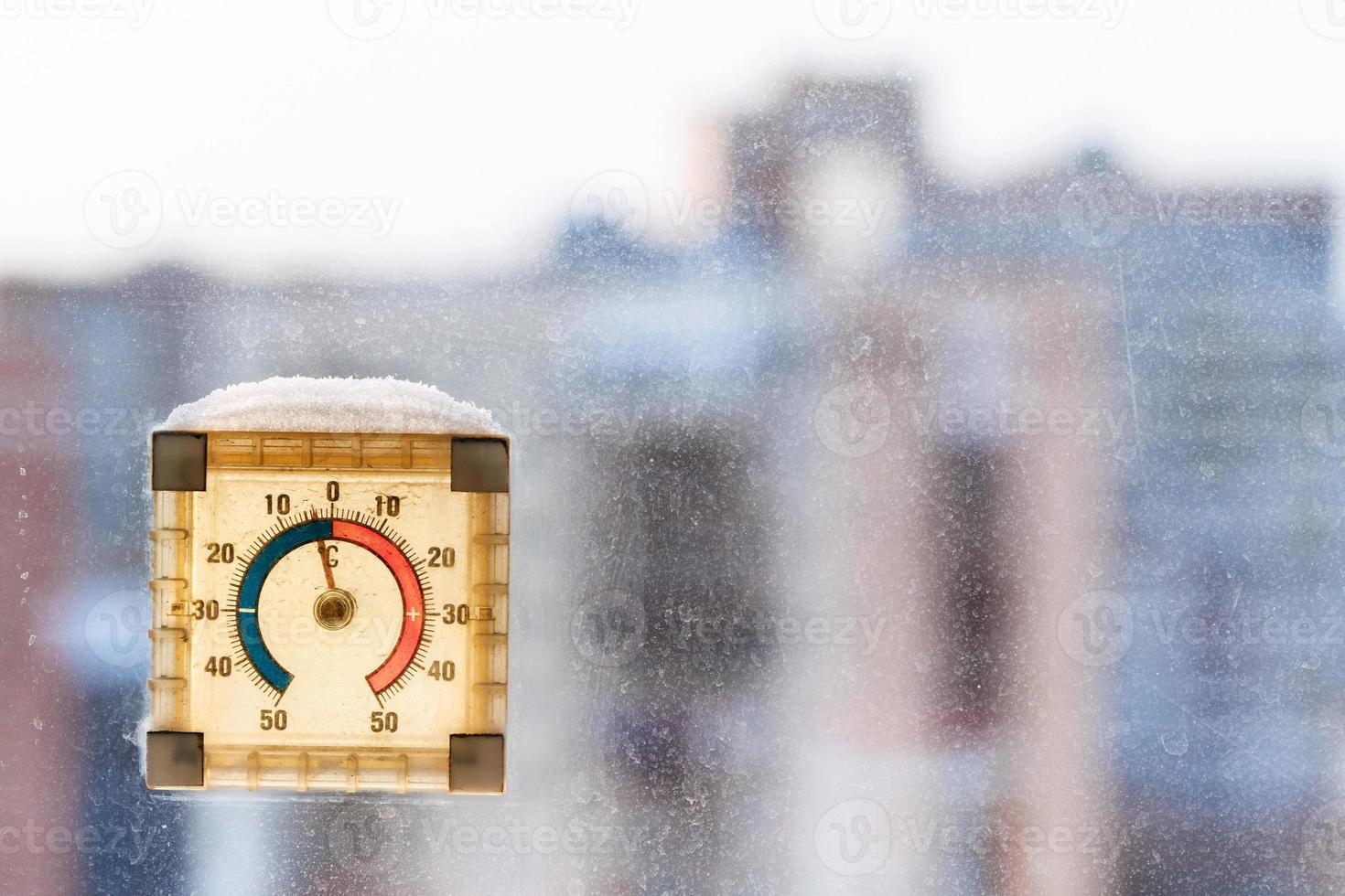 first frost in city - temperature on thermometer photo