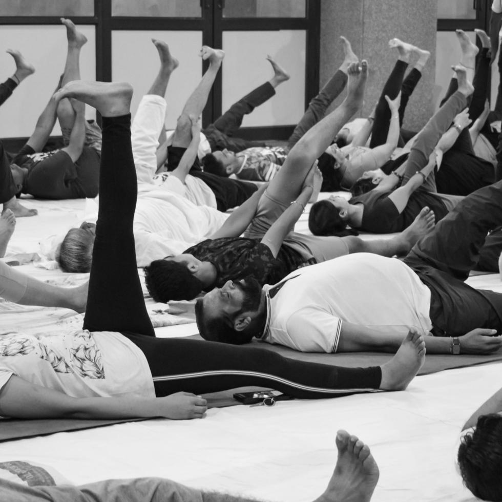 Delhi, India, June 19 2022-Group Yoga exercise session for people of different age groups in Balaji Temple,Vivek Vihar, International Yoga Day, Big group of adults attending yoga class-Black and White photo