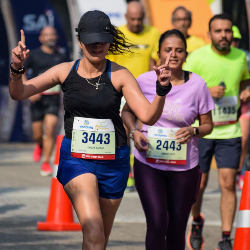 New Delhi, India - October 16 2022 - Vedanta Delhi Half Marathon race after covid in which marathon participants about to cross the finish line, Delhi Half Marathon 2022 photo