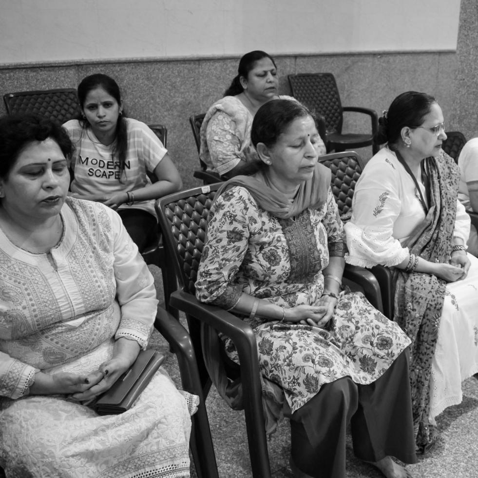 Delhi, India, June 19 2022-Group Yoga exercise session for people of different age groups in Balaji Temple,Vivek Vihar, International Yoga Day, Big group of adults attending yoga class-Black and White photo