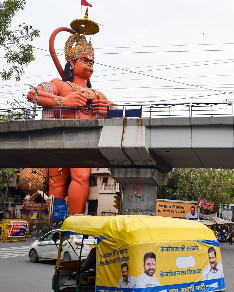 New Delhi, India - June 21, 2022 - Big statue of Lord Hanuman near the delhi metro bridge situated near Karol Bagh, Delhi, India, Lord Hanuman big statue touching sky photo