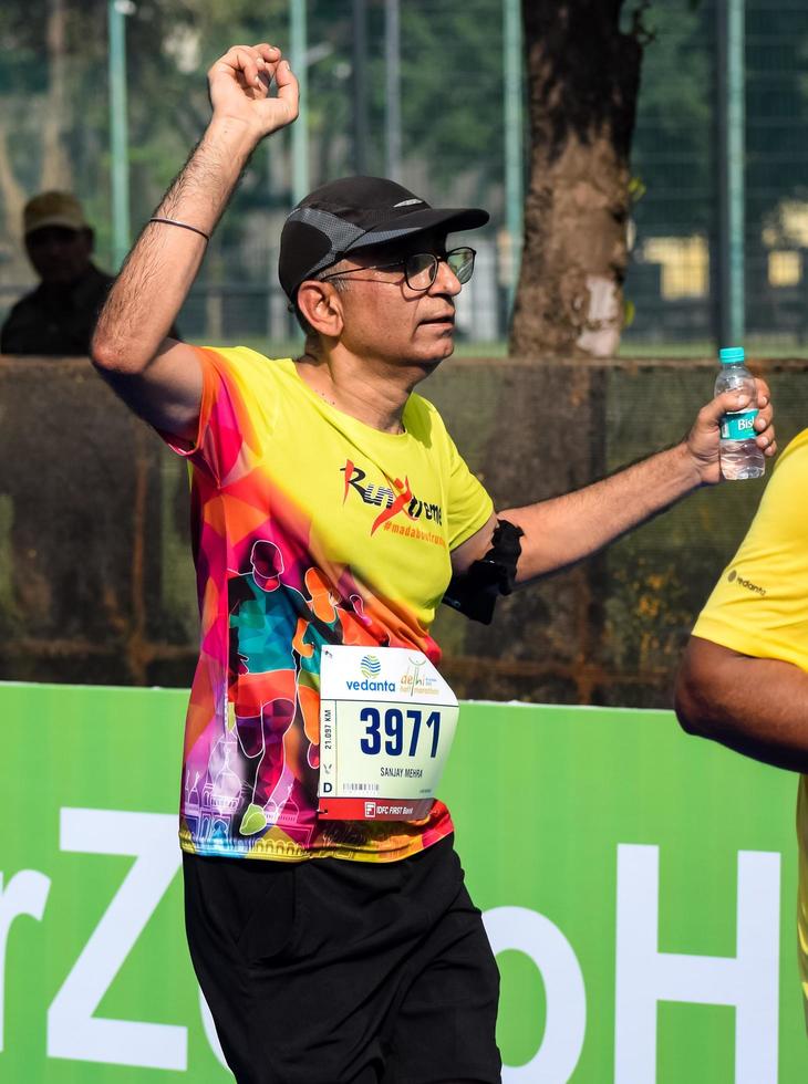 New Delhi, India - October 16 2022 - Vedanta Delhi Half Marathon race after covid in which marathon participants about to cross the finish line, Delhi Half Marathon 2022 photo