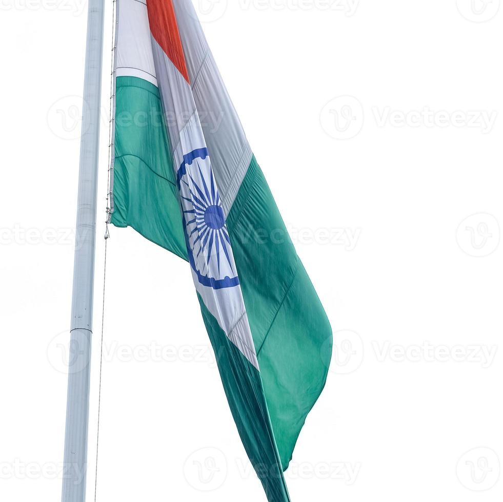 India flag flying high at Connaught Place with pride in blue sky, India flag fluttering, Indian Flag on Independence Day and Republic Day of India, tilt up shot, Waving Indian flag, Har Ghar Tiranga photo