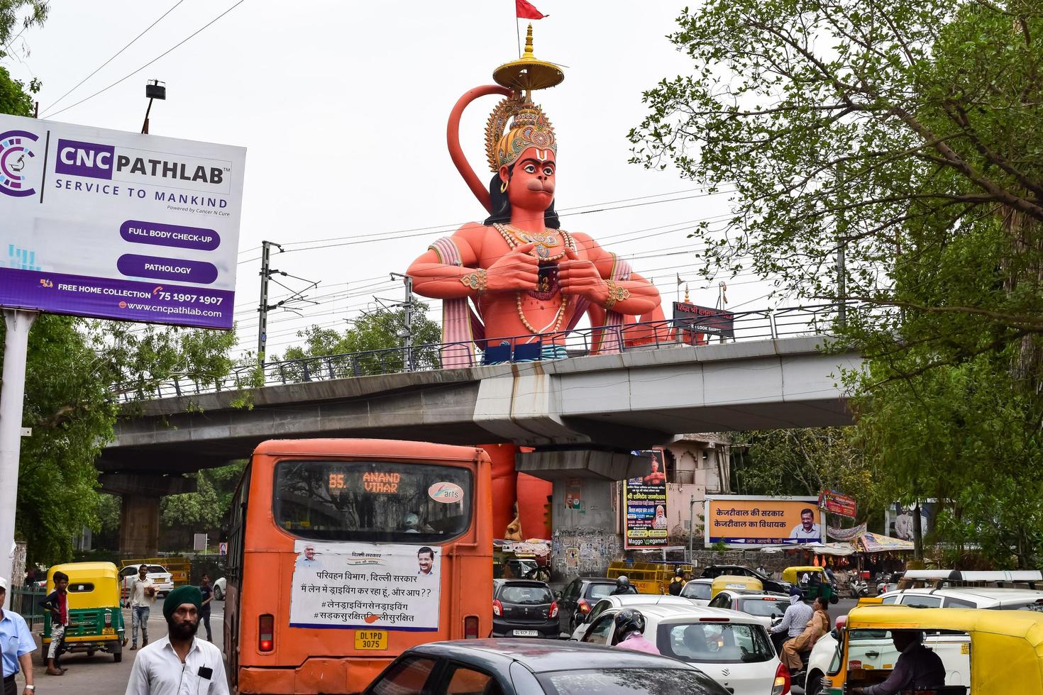 New Delhi, India - June 21, 2022 - Big statue of Lord Hanuman near the delhi metro bridge situated near Karol Bagh, Delhi, India, Lord Hanuman big statue touching sky photo