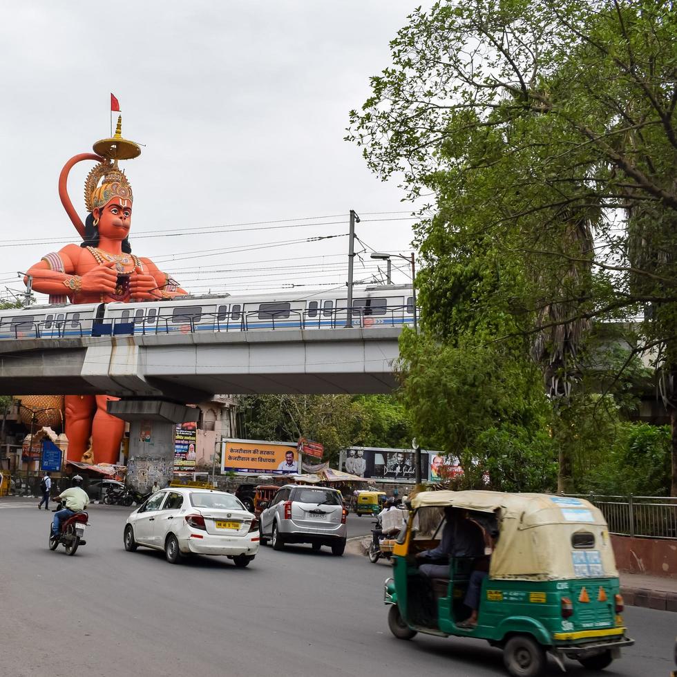 New Delhi, India - June 21, 2022 - Big statue of Lord Hanuman near the delhi metro bridge situated near Karol Bagh, Delhi, India, Lord Hanuman big statue touching sky photo
