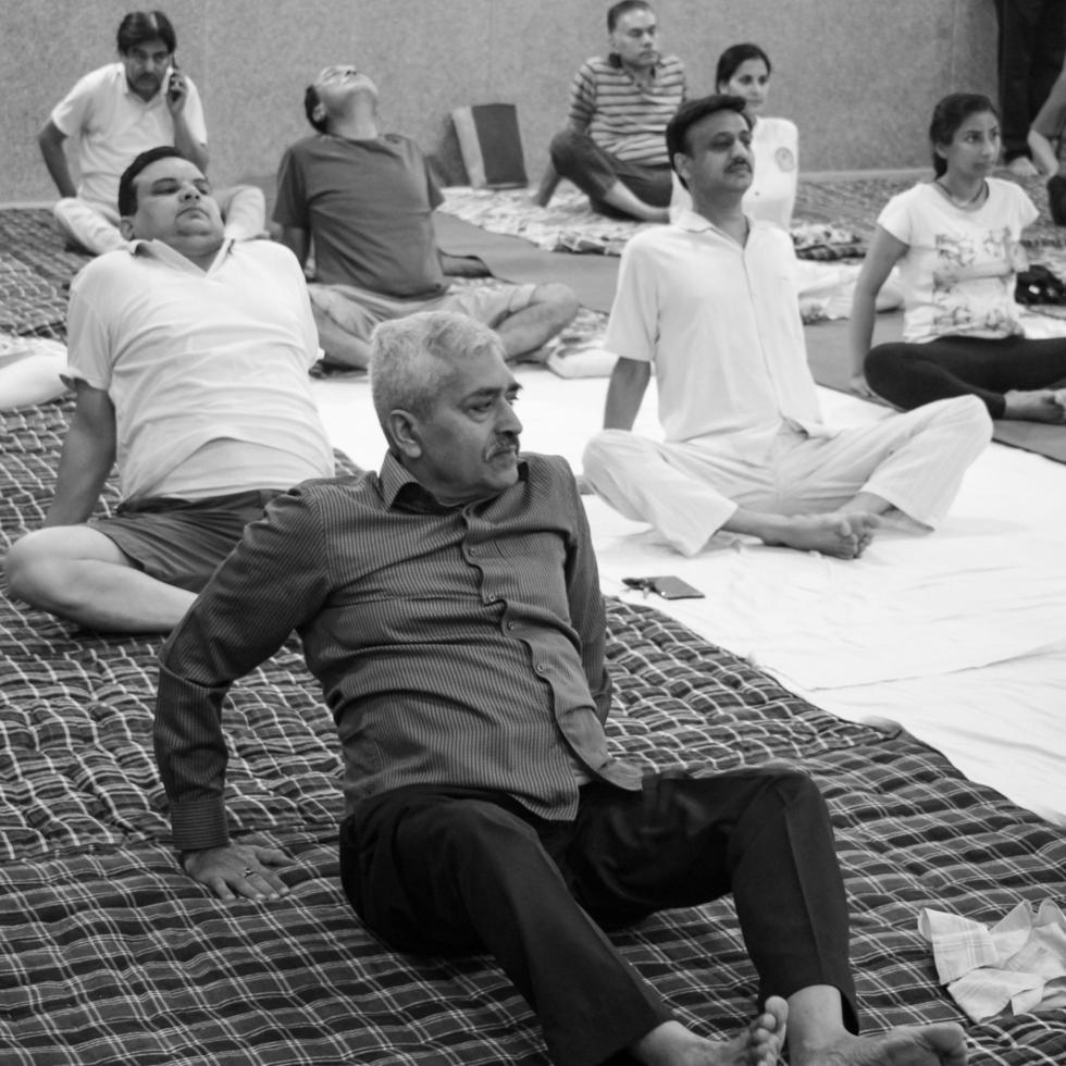 Delhi, India, June 19 2022-Group Yoga exercise session for people of different age groups in Balaji Temple,Vivek Vihar, International Yoga Day, Big group of adults attending yoga class-Black and White photo