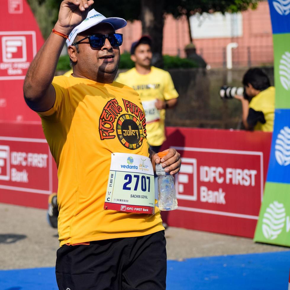 New Delhi, India - October 16 2022 - Vedanta Delhi Half Marathon race after covid in which marathon participants about to cross the finish line, Delhi Half Marathon 2022 photo
