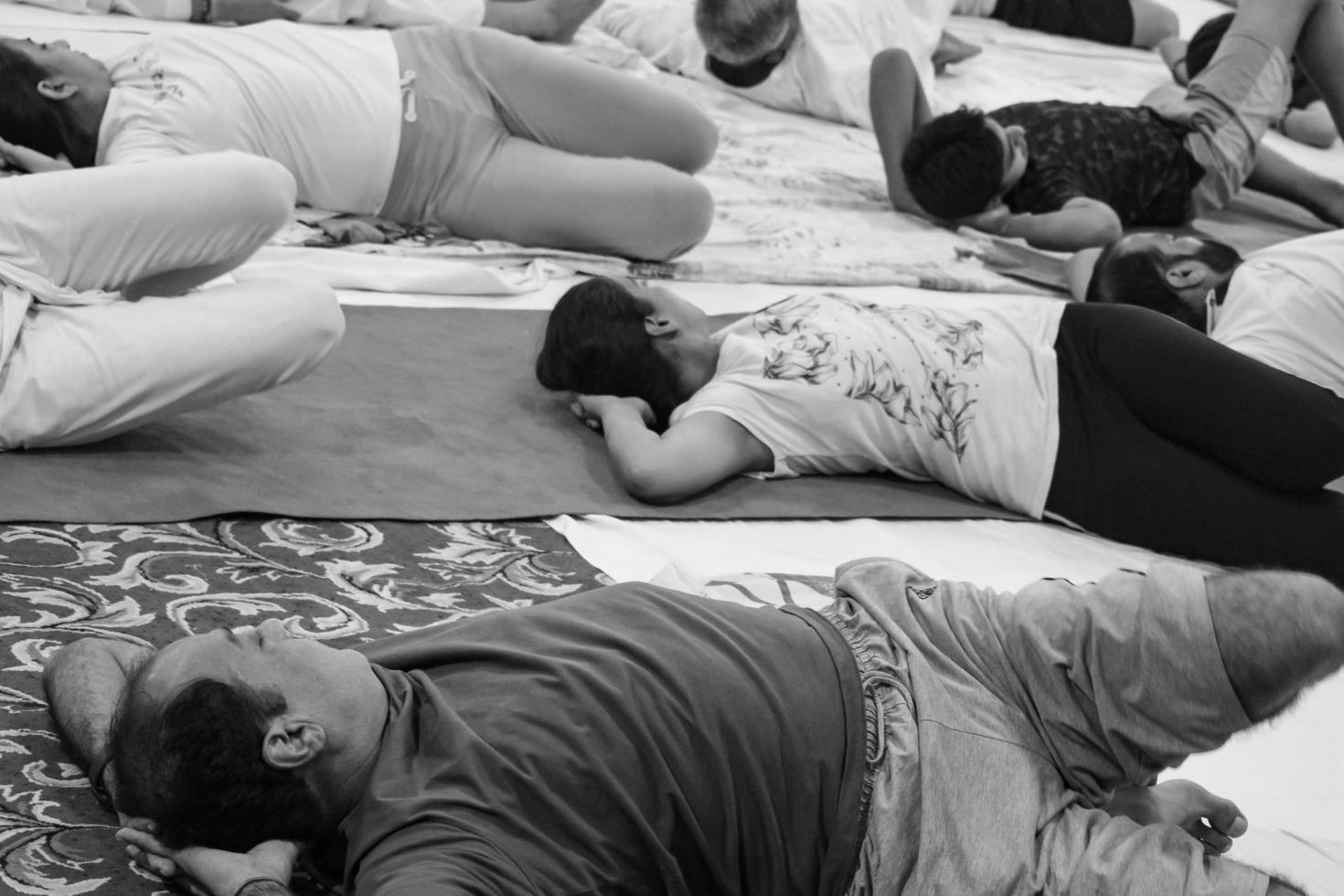 Delhi, India, June 19 2022-Group Yoga exercise session for people of different age groups in Balaji Temple,Vivek Vihar, International Yoga Day, Big group of adults attending yoga class-Black and White photo