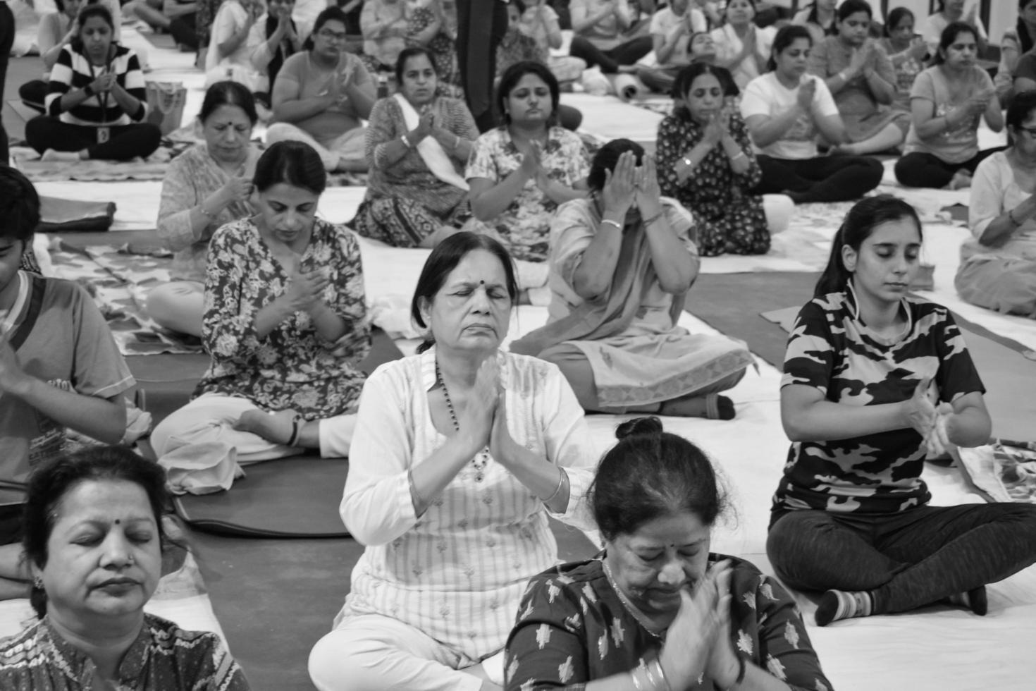Delhi, India, June 19 2022-Group Yoga exercise session for people of different age groups in Balaji Temple,Vivek Vihar, International Yoga Day, Big group of adults attending yoga class-Black and White photo