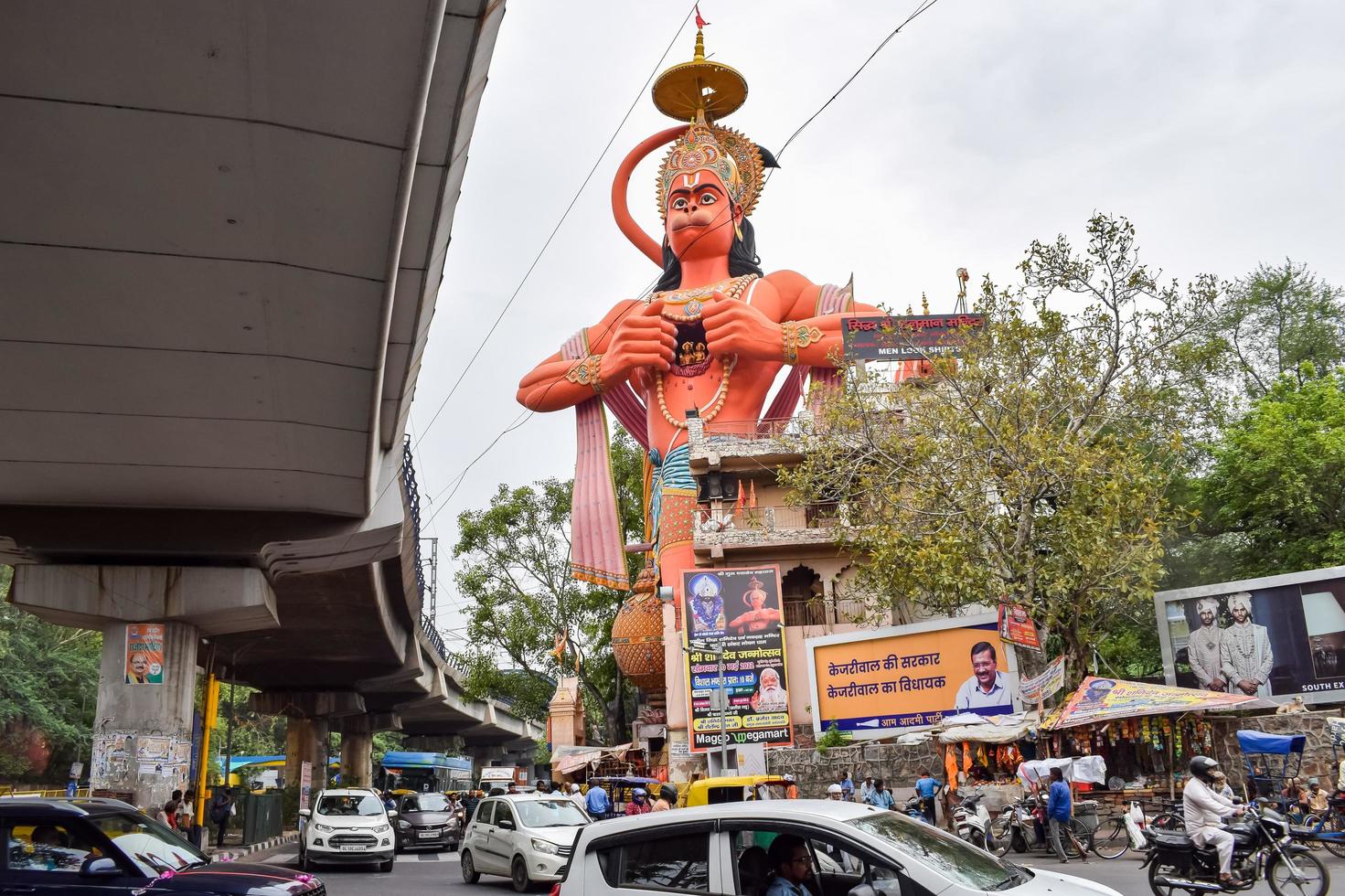 New Delhi, India - June 21, 2022 - Big statue of Lord Hanuman near the delhi metro bridge situated near Karol Bagh, Delhi, India, Lord Hanuman big statue touching sky photo