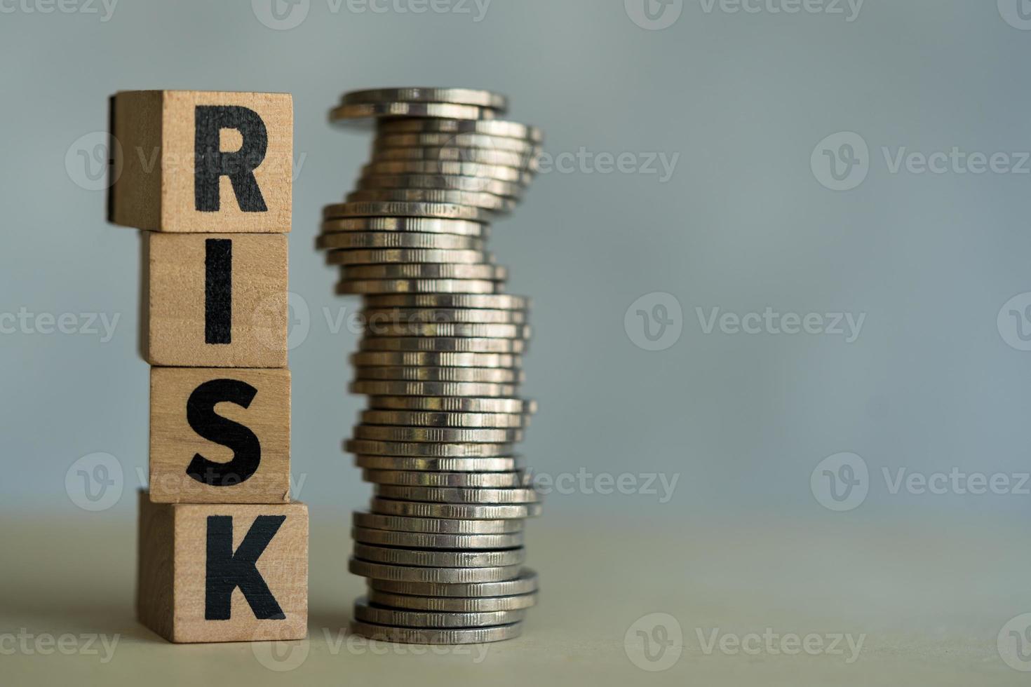 A pile of RISK cubes and pile coins are side by side. Risk management and assessment for business investment photo