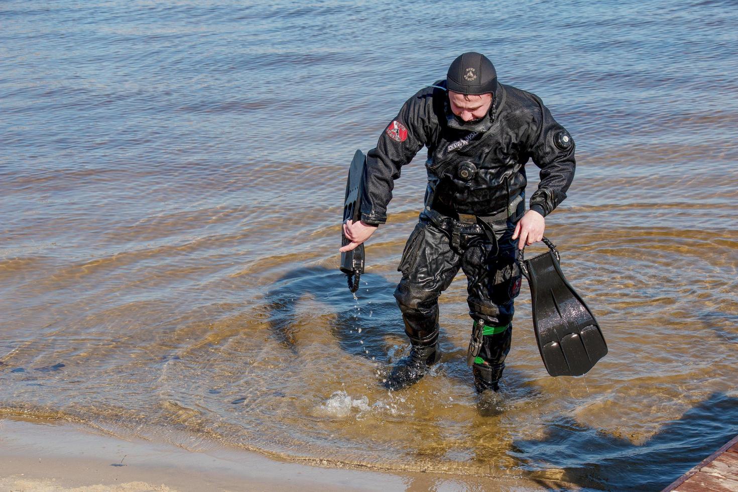 Dnepropetrovsk, Ukraine, Dnieper river - 02.21.2022 Professional diver near the river coastline. Commercial diving. Winter. photo