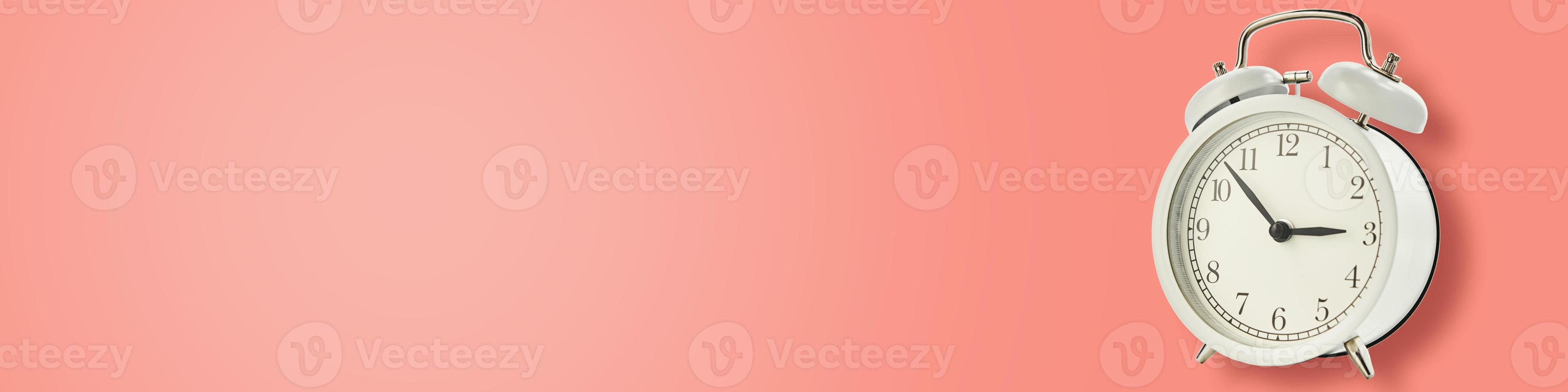 White vintage alarm clock on a blue background, long banner photo